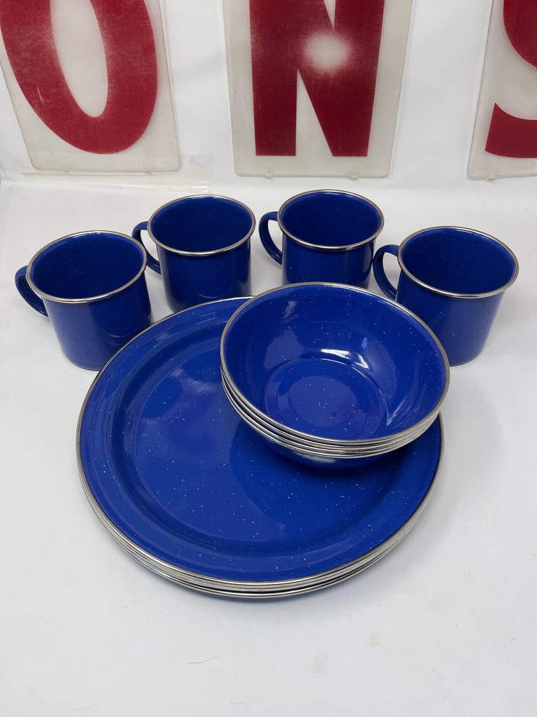 GSI Outdoors Enamel Table Set for Four features durable stainless steel bowls, plates, and mugs, ideal for camping or dining use.