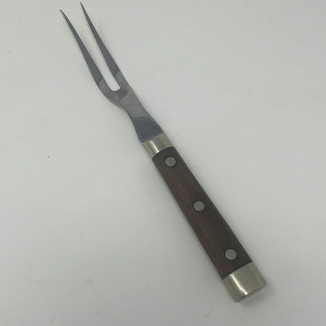 Vintage stainless steel 2-prong carving fork with wooden handle, ideal for slicing roasts. Crafted in the 1950s, a timeless kitchen utensil.