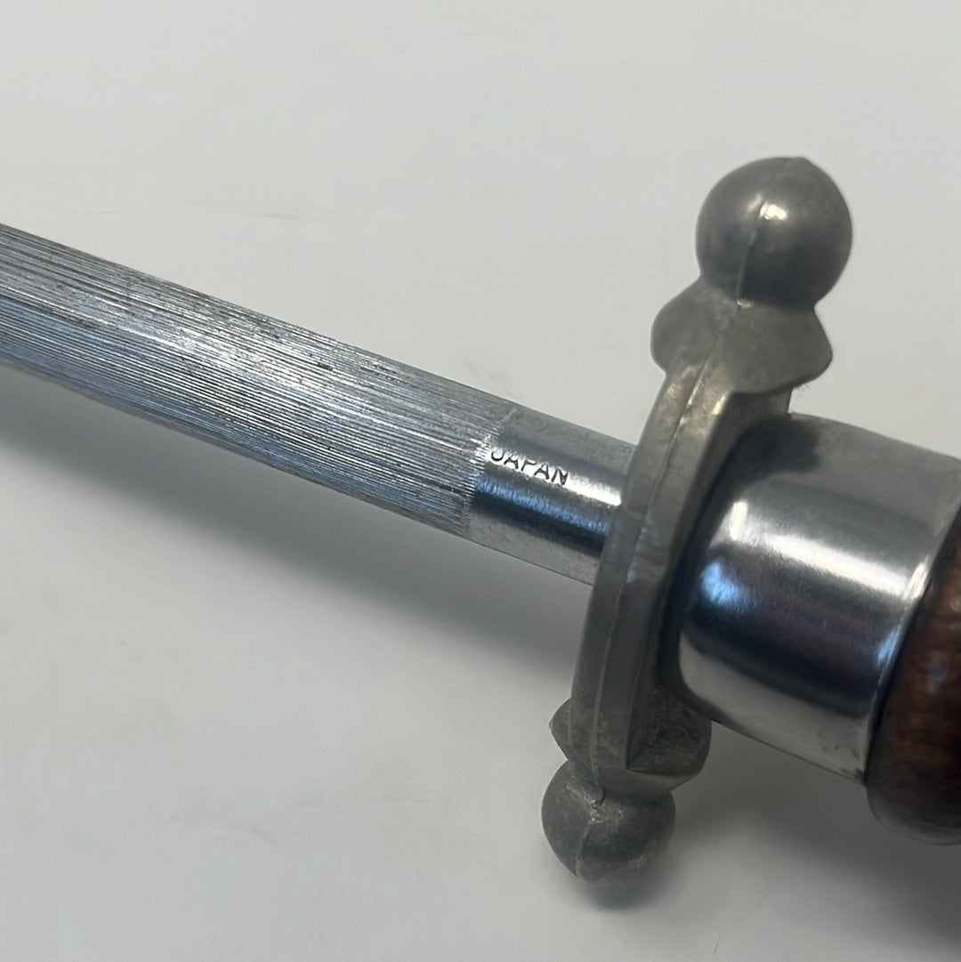 Alt text: A close-up of a honey honing rod with a metal ring for storage, resembling a honey stirrer handle.