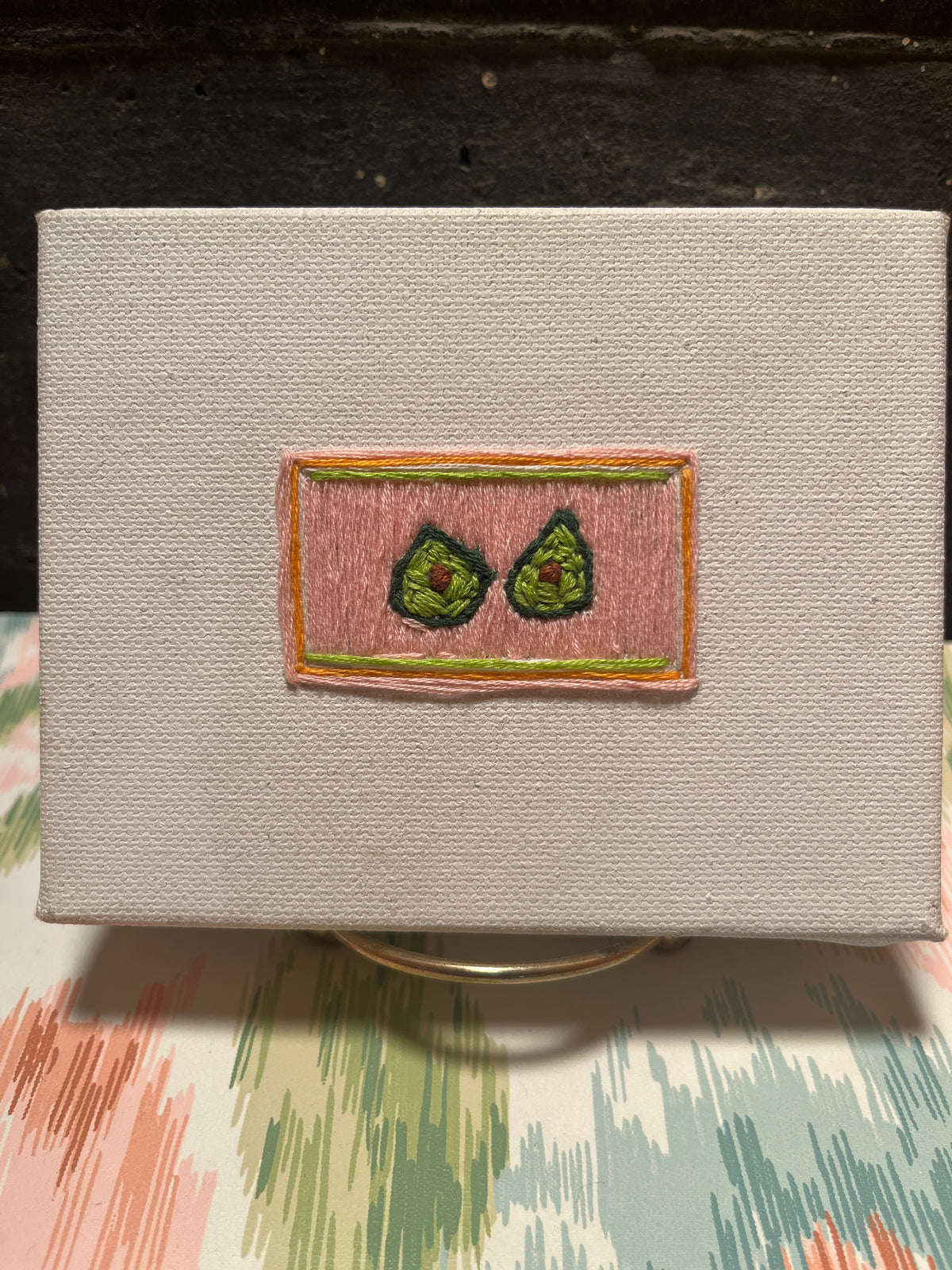 “Avocado Slice” (2026) - embroidery on canvas - Vibrantly Earthy