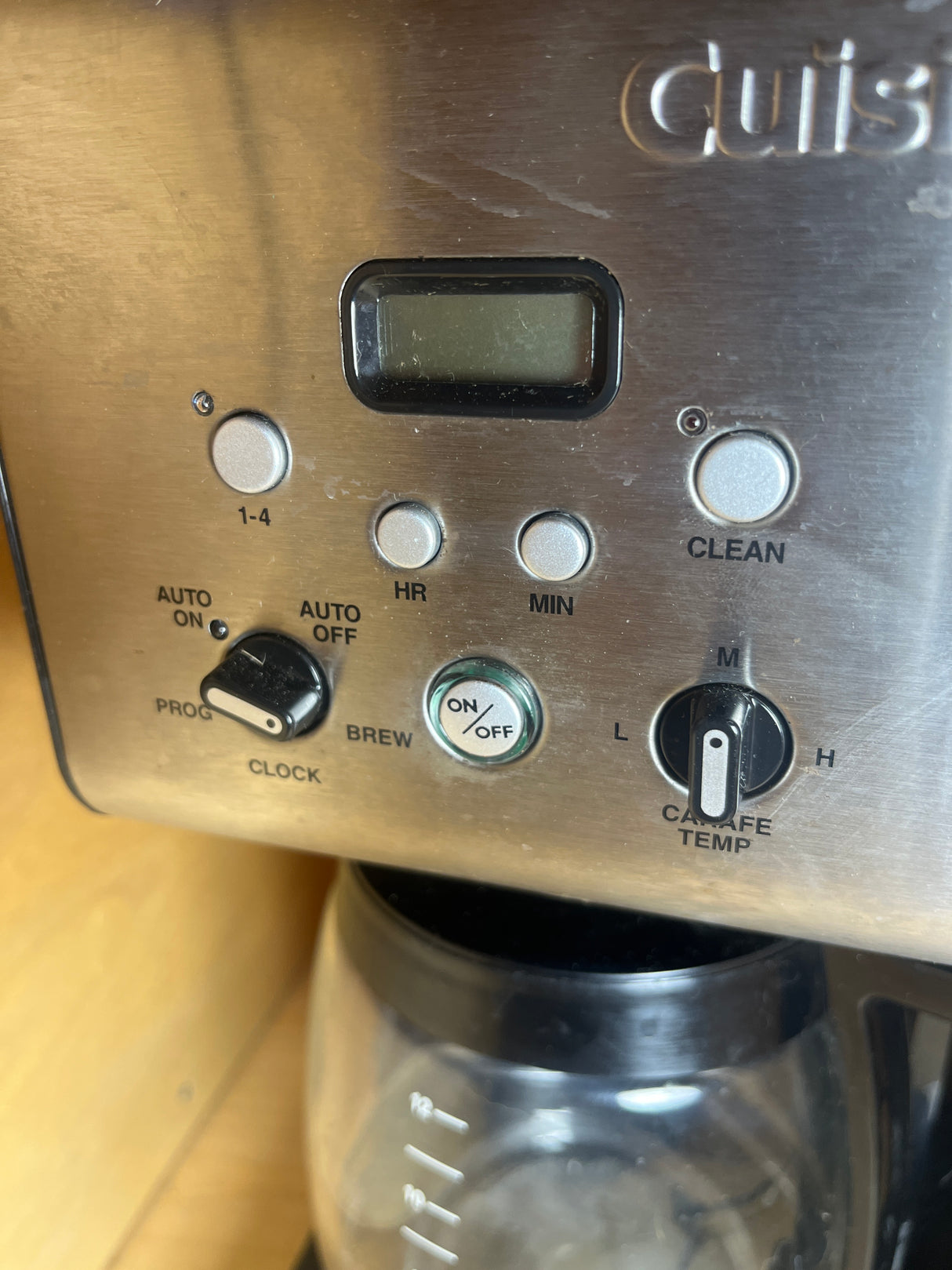 12-cup Cuisinart coffee maker with hot water dispenser, featuring a control panel with LCD, customizable settings, and glass carafe for convenient brewing.