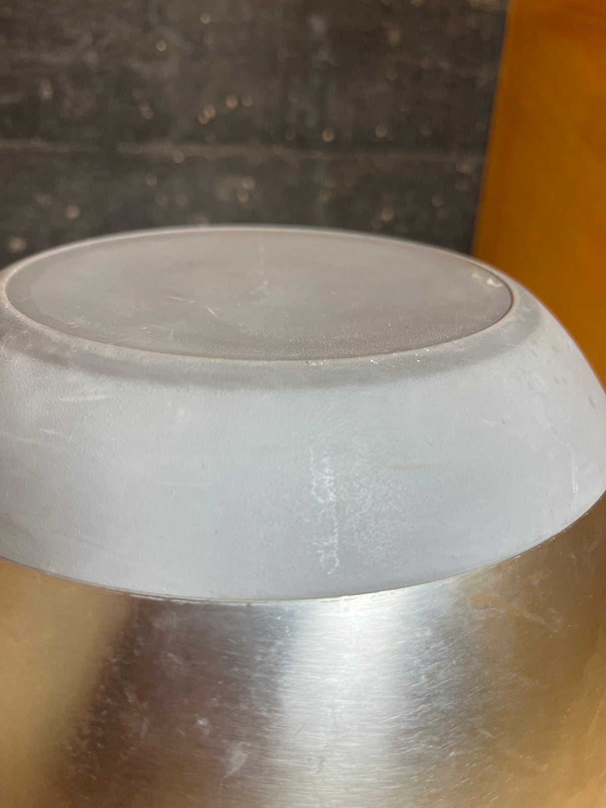 Underside view of a stainless steel mixing bowl featuring a gray silicone nonskid base, highlighting its sturdy design for stable mixing.