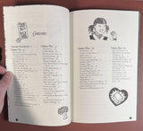 Open cookbook Cook Your Own Fucking Life: Vegan Comfort Food Recipes, displaying contents with whimsical doodles, highlighting diverse recipes like Broccoli Soup and Chocolate Cupcakes.