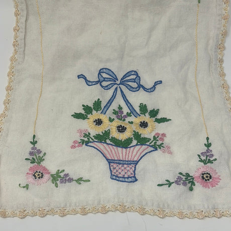 Hand-embroidered table runner with Black-Eye Susan flower vases, showcasing intricate detailing on white fabric.