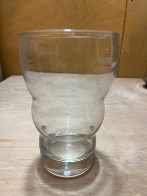 Wavy sided tall drinking glass showcased on a wooden surface, highlighting its double-walled, contoured design for stylish and functional use.