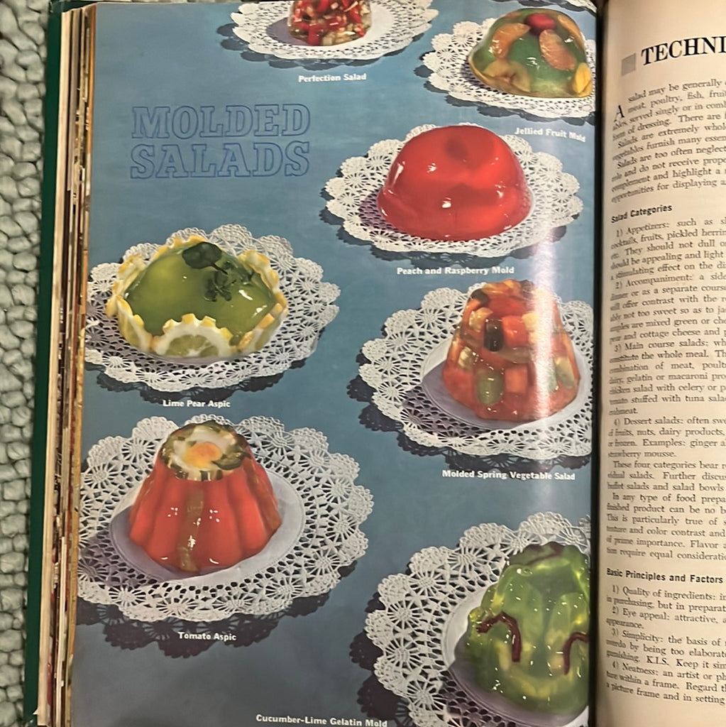 A photo of brightly colored molded salads arranged on doily plates on a blue backdrop from The Professional Chef textbook. From Spoons Kitchen Exchange.