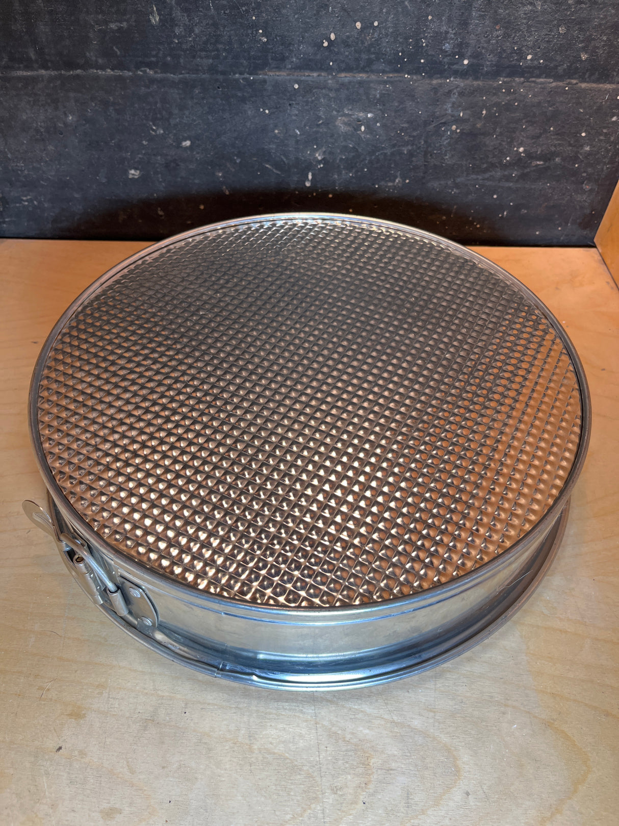 RARE Cold War springform cake pan - 12” tin made in W. Germany, featuring a latch and removable bottom, displayed on a wooden surface.