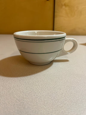 Homer Laughlin China set featuring plates, bowls, saucers, mugs, and a creamer, elegantly arranged to showcase their classic design and fine craftsmanship.