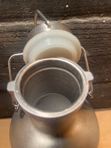 Top view of a Flip top beer growler - stainless steel 64oz, showcasing its open swing-top lid and empty interior, emphasizing its robust, resealable design.