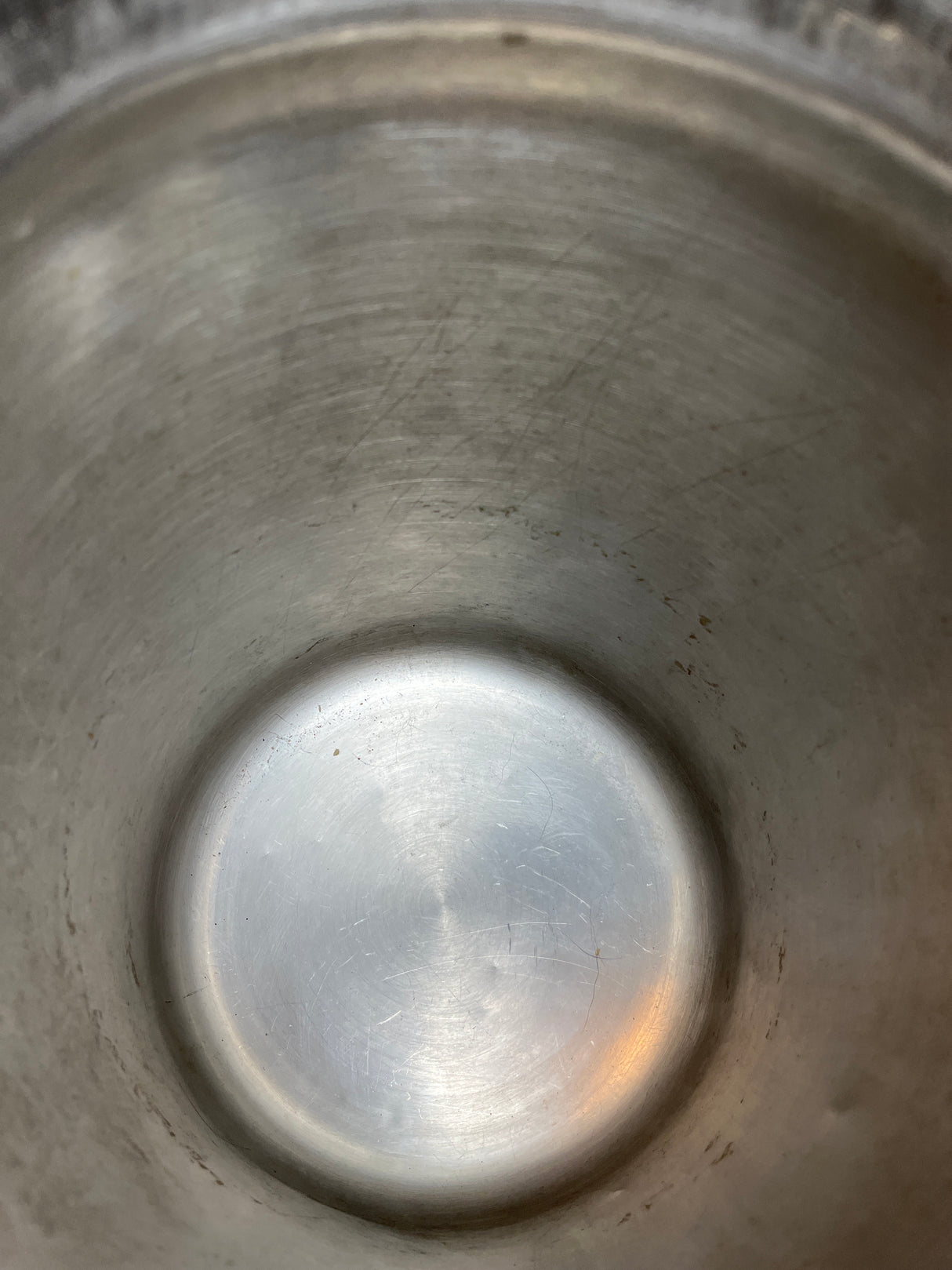 Interior of a Vintage John Wood Young’s Dairy stainless steel milk can, showcasing its smooth, slightly scratched surface, emphasizing its durable, empty metal interior.