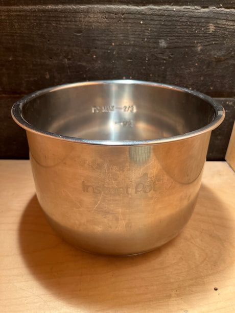 Instant Pot cooker stainless steel inner pot replacement for 6 quart, showing faint logo and fill-level markings (Max 2/3, 1/2) on the inner surface.