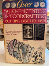 Oster Kitchencenter & Foodcrafter cutting disc holder, a clear acrylic rack for organizing food processor discs, usable on countertops or wall-mounted.