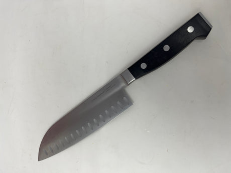 Simply Calphalon 7” Santoku knife designed for chopping crispy produce and fresh herbs, featuring a broad, sharp blade suitable for various kitchen tasks.