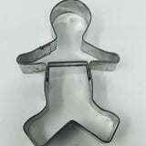 Mid century metal cookie cutters in various shapes, including a person and group designs.