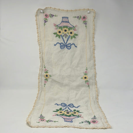 Hand-embroidered table runner with Black-Eye Susan vases motif. Delicate floral design with intricate fabric edging.