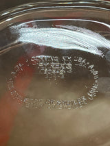 Underside view of Oval casserole baking dish with lid - PYREX 804-B, showcasing embossed markings including “Pyrex,” model numbers, and usage warnings.