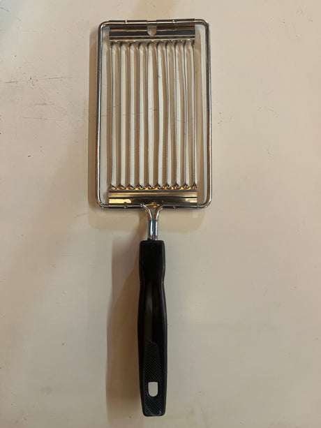 Serrated tomato/cheese slicer stainless steel with a black handle, featuring parallel wires for clean, even cuts. Ideal for precise slicing of delicate produce.