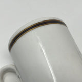 Close-up of a Homer Laughlin Best China USA espresso cup, featuring glossy white ceramic with black and gold trim. Ideal for a vintage touch to coffee settings.