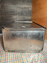Bread box drawer insert with sliding lid, made of weathered, galvanized steel, featuring a hinged top and handmade labels, ideal for dry pantry storage.