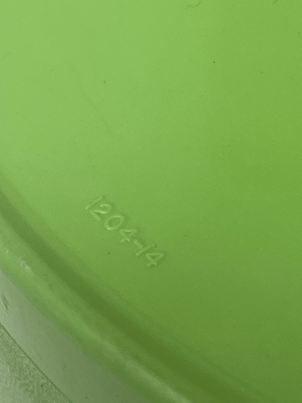 Vintage olive green Tupperware food storage container with lid (model 1204-14), featuring minor scuffing on the outer edge, ideal for preserving food freshness.
