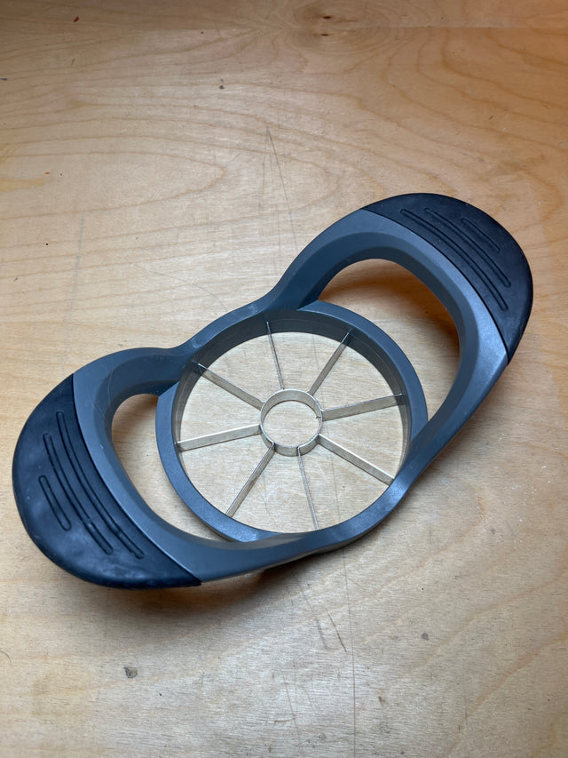 Pineapple corer - Hamilton Beach: A stainless steel tool with grippy silicone and plastic handles, designed for coring and slicing pineapples effortlessly.