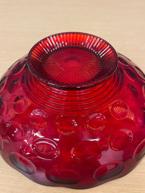 Imperial Glass Co. ruby red creamer and sugar bowl set featuring a thumbprint design with wavy edges, showcased in a close-up of its intricate details.