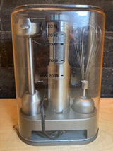 Cuisinart stick blender and whisk set HB-800PC in storage stand; includes motor housing, stainless steel blending wand, whisk attachment, cord-storing base, and doubles as a mixing bowl.