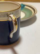 Paragon after dinner demitasse cup and saucer set, featuring intricate blue, green, white, and gold stripes, showcasing delicate English China craftsmanship.