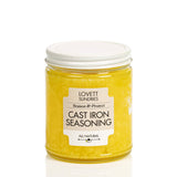 Lovett Sundries Cast Iron Seasoning Oil in a clear jar, featuring a yellow, wax-like compound for seasoning and protecting cast iron cookware.