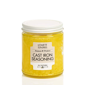 Lovett Sundries Cast Iron Seasoning Oil in a clear jar, featuring a yellow, wax-like compound for seasoning and protecting cast iron cookware.