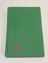 Leone’s Italian Cookbook (1967 First Edition) with a plain green cover, featuring a red leaf graphic in the corner, photographed on a white surface.