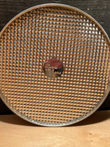 4-piece springform pan set - Pampered Chef includes a round, perforated pizza pan with a center medallion stamped “THE PAMPERED CHEF ® • CHILE.”