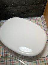 4-liter oval casserole dish with lid - PYREX Corning Ware French White F-14-B, on a patterned tablecloth, accompanied by a clear glass serving spoon.