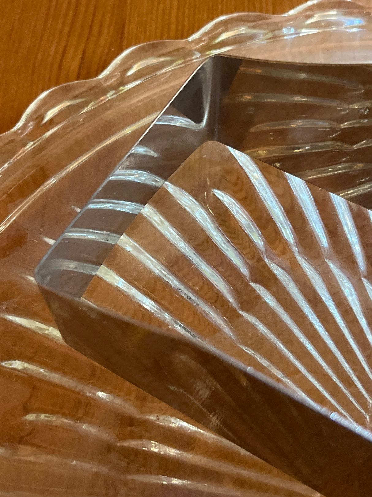 Square Kake-kut’r on ribbed tray, nestled within a scalloped platter, perfect for effortlessly cutting, lifting, and serving desserts with one hand.