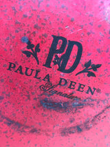 Tea kettle - steel red speckled enamelware - Paula Deen, showing its underside with a PD logo and branding, highlighting its durable steel and comfortable black silicone handle.