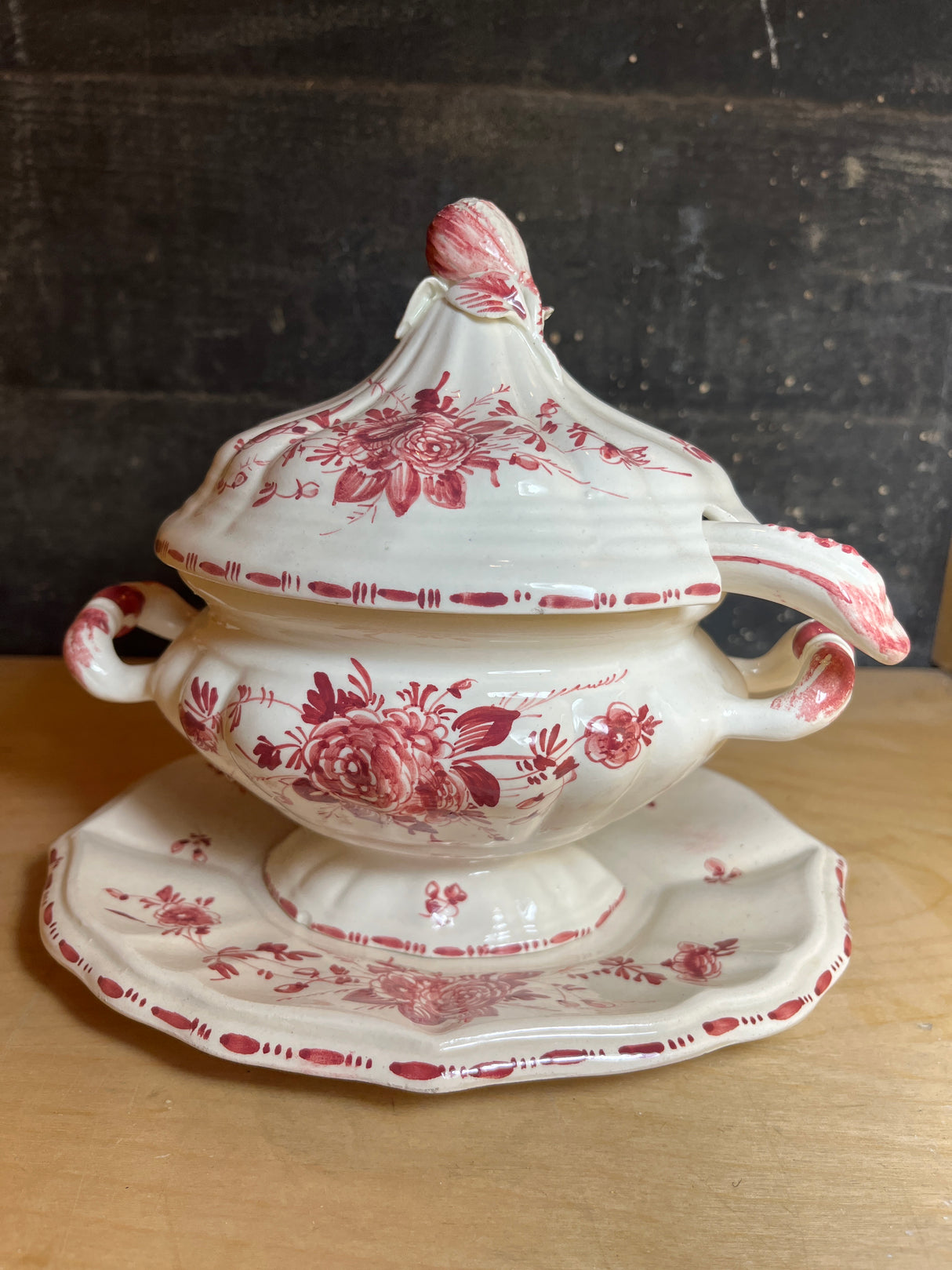 Porcelain soup tureen bowl with lid, underplate, and ladle, hand-painted with red roses, featuring side handles and a ladle slot, made in Italy.