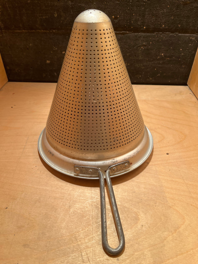 Cone sieve strainer with wide base - aluminum unknown brand; vintage cone-shaped metal sieve with sturdy handle, ideal for pressing sauces and preparing large batches.