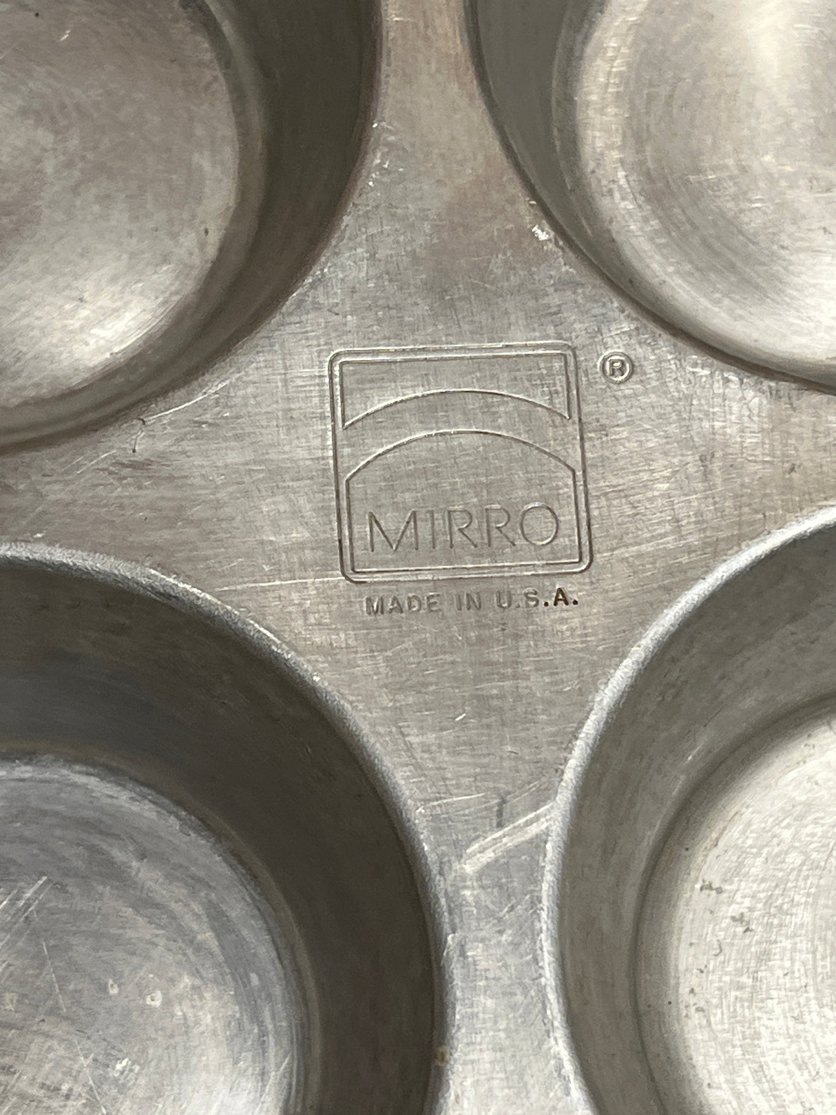Mirro USA aluminum muffin cupcake pan with 6 2.5D holes, stamped logo and “Made in U.S.A.,” showcasing vintage charm and durability for baking.