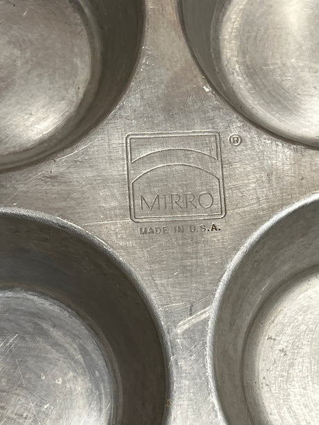 Mirro USA aluminum muffin cupcake pan with 6 2.5D holes, stamped logo and “Made in U.S.A.,” showcasing vintage charm and durability for baking.