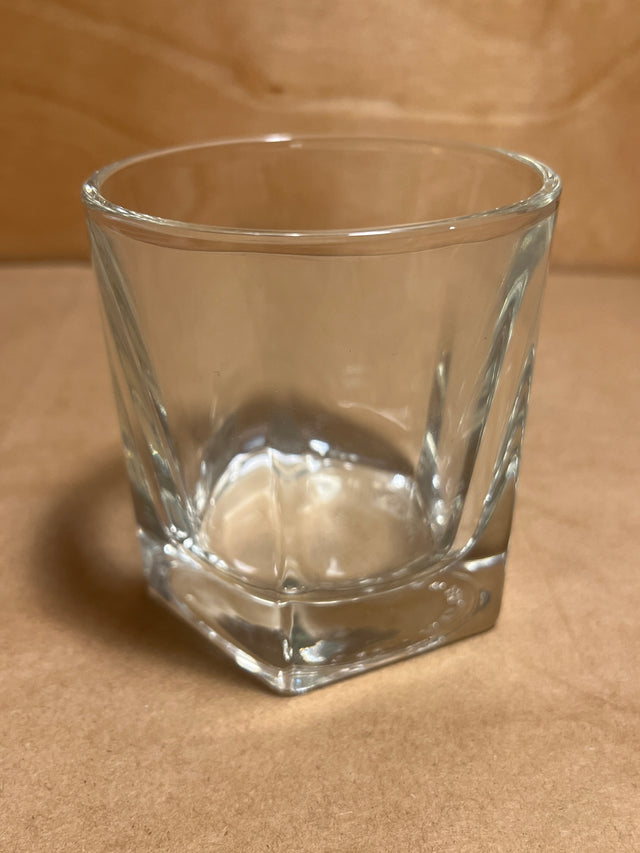 Libbey Duratuff pentagonal whiskey tumbler glass, 6oz, with a thick base and gently flared sides, sits empty on a brown surface.