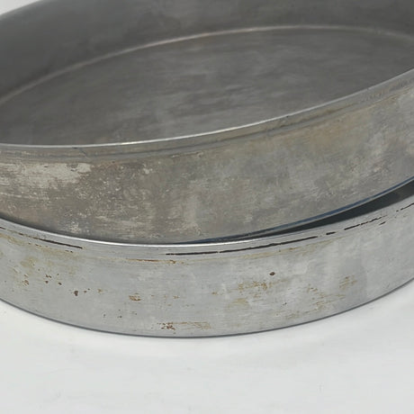 Close-up of aluminum round cake pans, set of 2, showcasing lightweight and durable design. Metal kitchenware for baking enthusiasts.