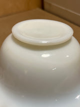 Bowl n plate: An upside-down view of a ceramic bowl, showcasing its foot ring and smooth base, highlighting its simple, elegant curvature.