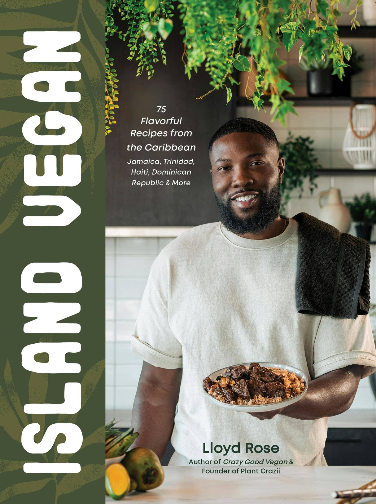 Cover of Island Vegan: 75 Caribbean Recipes From Jamaica & More by Lloyd Rose, featuring him in a kitchen with a plant-based dish, fruits, and greenery.