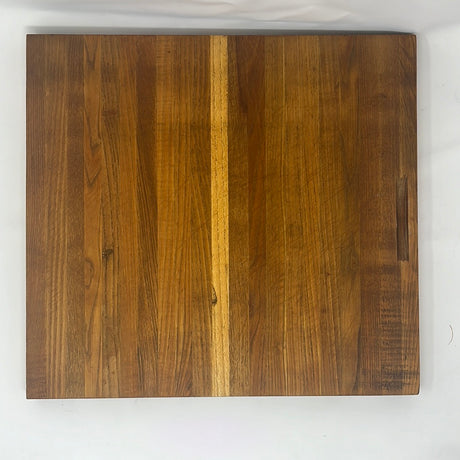 Solid wood cutting board made of wood pieces of slightly different golden brown tones. Minor scuffs from normal use. From Spoons Kitchen Exchange.