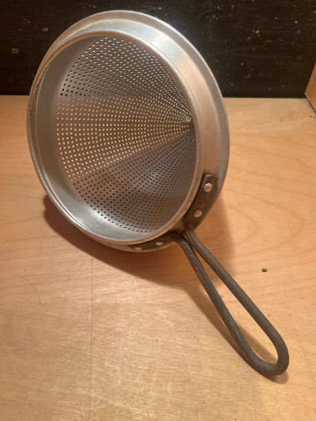 Tiny pointy cone sieve strainer - aluminum with fine perforations, looped handle, and sturdy construction, ideal for canning. Note: small dent at cone tip.