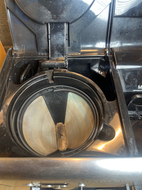 View inside the 12-cup Cuisinart coffee maker's brew basket with built-in gold-tone mesh filter, highlighting its convenience for brewing perfect coffee.