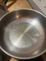 Seal-O-Matic Thermium Multi-Plex 18-8 Stainless Steel 11” Skillet, showing a scratched interior on a wooden surface, highlighting durability and resin handle quality.