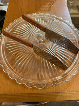 Square Kake-kut’r serving spatulas with wooden handles on a scalloped glass platter, designed for easy one-handed dessert serving from sheet cakes or brownies.