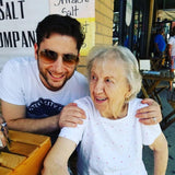 Young man and older woman at a market table, promoting NEW Pierogi Salt! A flavorful blend for pierogis and more, inspired by Grandma's kitchen.