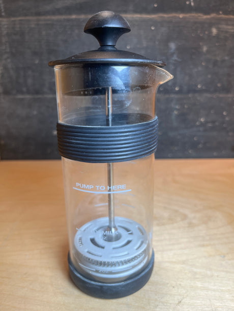 Ninja Easy Frother, a manual milk foamer with a PUMP TO HERE mark, designed to froth hot or cold milk directly in the glass.